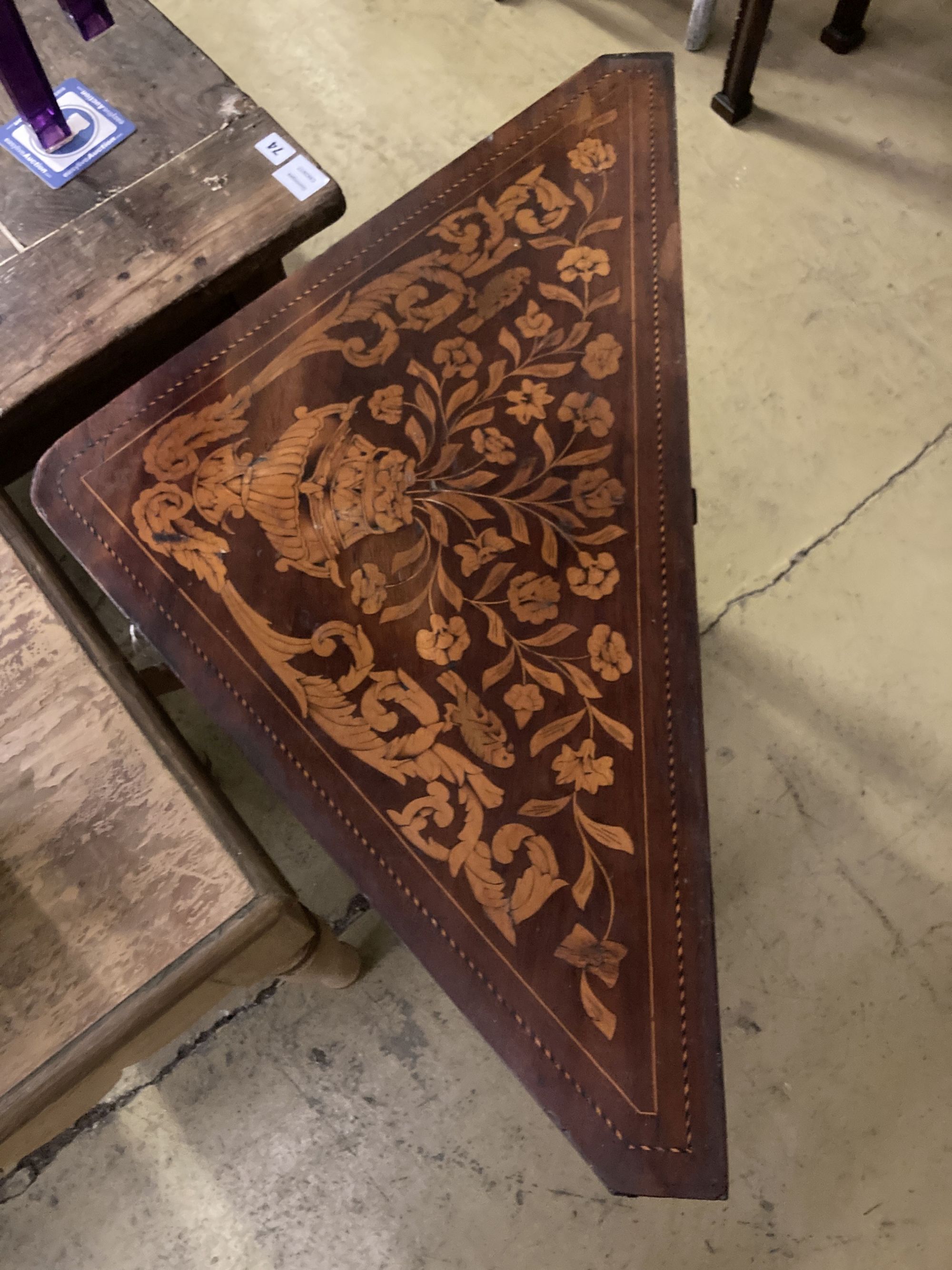 An early 19th century Dutch marquetry inlaid walnut triangular folding tea table, width 93cm, depth 51cm, height 76cm